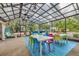 Large screened patio featuring dining, lounge, and hammock areas, perfect for relaxing and enjoying the outdoors at 6343 Hollywood Blvd, Sarasota, FL 34231