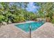Inviting pool area with lush landscaping, lounge chairs, and serene atmosphere, perfect for outdoor relaxation and recreation at 6343 Hollywood Blvd, Sarasota, FL 34231
