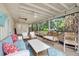 Inviting screened porch with comfortable seating and a ceiling fan, offering a serene outdoor living space at 6343 Hollywood Blvd, Sarasota, FL 34231