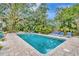 Backyard swimming pool with brick pavers, lounge chairs, and lush tropical landscaping at 6343 Hollywood Blvd, Sarasota, FL 34231