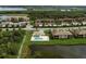 Aerial view of the community pool, surrounding landscaping, and condos in this lovely planned community at 6509 Grand Estuary Trl # 203, Bradenton, FL 34212