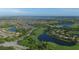 An aerial view of the community with lakes, a golf course, and sidewalks, highlighting the neighborhood's layout and design at 6509 Grand Estuary Trl # 203, Bradenton, FL 34212