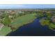 Scenic aerial view of a lush golf course, lake, and homes in a beautiful community at 6509 Grand Estuary Trl # 203, Bradenton, FL 34212