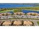 Beautiful aerial view of the condos, parking, golf course, and waterfront views in this lovely planned community at 6509 Grand Estuary Trl # 203, Bradenton, FL 34212