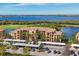 Gorgeous condo building with lush landscaping, covered parking, golf course and lovely water view at 6509 Grand Estuary Trl # 203, Bradenton, FL 34212