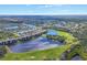 Aerial view of residential area with numerous buildings, lakes, golf course, and landscaping at 6509 Grand Estuary Trl # 203, Bradenton, FL 34212