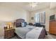 Comfortable bedroom with a ceiling fan, desk, and TV for relaxed living at 6509 Grand Estuary Trl # 203, Bradenton, FL 34212