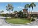 Exterior view of the clubhouse featuring palm trees and well manicured landscaping, welcoming members and guests alike at 6509 Grand Estuary Trl # 203, Bradenton, FL 34212