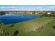 Scenic golf course features a driving range overlooking a large lake with palm trees, green lawns and blue skies at 6509 Grand Estuary Trl # 203, Bradenton, FL 34212