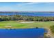 Beautiful aerial view of a lush green golf course with lake and waterfront scenery at 6509 Grand Estuary Trl # 203, Bradenton, FL 34212