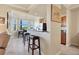 A view of the open kitchen with stainless steel appliances and granite countertops overlooking the breakfast nook at 6509 Grand Estuary Trl # 203, Bradenton, FL 34212
