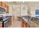 Well-equipped kitchen with granite countertops, stainless steel appliances, and open access to the dining area at 6509 Grand Estuary Trl # 203, Bradenton, FL 34212
