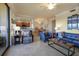 Inviting living room with tile floors, comfortable seating, and a seamless flow into the dining area and kitchen at 6509 Grand Estuary Trl # 203, Bradenton, FL 34212