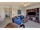 Cozy living room with a large TV, comfortable blue seating, and stylish décor at 6509 Grand Estuary Trl # 203, Bradenton, FL 34212