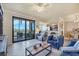 Bright and airy living room with comfortable seating, tile floors, and sliding doors to a private patio at 6509 Grand Estuary Trl # 203, Bradenton, FL 34212