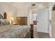 Cozy main bedroom with plush bed, dresser, and adjacent bathroom at 6509 Grand Estuary Trl # 203, Bradenton, FL 34212