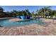 Relaxing community pool area with comfortable lounge chairs, lush landscaping, and inviting waters at 6509 Grand Estuary Trl # 203, Bradenton, FL 34212