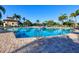 Inviting outdoor swimming pool surrounded by tropical landscaping and lounge chairs for relaxation at 6509 Grand Estuary Trl # 203, Bradenton, FL 34212