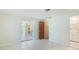 Clean, bright bedroom with an open doorway to an adjoining living space at 6529 Seagate Ave, Sarasota, FL 34231