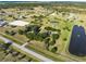 Expansive aerial view of a sprawling property with ponds, mature trees, and a horse arena for luxurious country living at 6605 253Rd St E, Myakka City, FL 34251