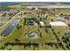 A captivating property with ponds, mature trees, a horse arena, offering a harmonious blend of luxury and nature at 6605 253Rd St E, Myakka City, FL 34251