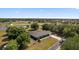 Gorgeous aerial view showcasing a home with a pond, mature trees, and lush green space at 6605 253Rd St E, Myakka City, FL 34251