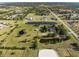 A tranquil property featuring multiple ponds, lush greenery, a horse arena, and ample space for outdoor enjoyment at 6605 253Rd St E, Myakka City, FL 34251