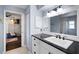 White bathroom with black countertop and hexagon tile floor at 6605 253Rd St E, Myakka City, FL 34251
