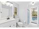 Bright bathroom with white vanity, shower, and view of the pool area at 6605 253Rd St E, Myakka City, FL 34251