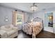 Bedroom with hardwood floors, floral bedding, and an ensuite bathroom at 6605 253Rd St E, Myakka City, FL 34251