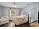 Bedroom with hardwood floors, floral bedding, and an ensuite bathroom at 6605 253Rd St E, Myakka City, FL 34251