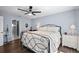 Bright bedroom with a decorative wrought iron bed, wood-look floors, and a window providing plenty of natural light at 6605 253Rd St E, Myakka City, FL 34251