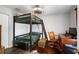 Bedroom with a stylish bunk bed and desk, perfect for study and sleep at 6605 253Rd St E, Myakka City, FL 34251