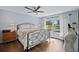 Cozy bedroom with wood-look tile floors, a comfortable bed, and a window with natural light at 6605 253Rd St E, Myakka City, FL 34251
