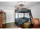 Bedroom featuring a bunk bed, wooden floors, and ample storage space at 6605 253Rd St E, Myakka City, FL 34251