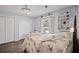 Bedroom featuring hardwood floors, closets, and floral bedding at 6605 253Rd St E, Myakka City, FL 34251