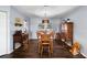 Inviting dining area featuring hardwood floors and a classic wooden dining set with ample seating at 6605 253Rd St E, Myakka City, FL 34251