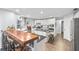Modern kitchen with white cabinets, stainless steel appliances, a large island, and a breakfast bar with seating at 6605 253Rd St E, Myakka City, FL 34251
