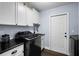 Well-equipped laundry room with modern washer, dryer, and ample storage at 6605 253Rd St E, Myakka City, FL 34251