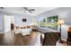 Comfortable living room features hardwood floors, a cozy white sofa, and a large window with views of the outdoors at 6605 253Rd St E, Myakka City, FL 34251