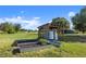 Exterior view of the water treatment system with raised garden beds in a well-maintained yard at 6605 253Rd St E, Myakka City, FL 34251
