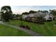 Expansive lawn and landscaping surround this house with solar panels and screen patio at 6702 Drewrys Blf, Bradenton, FL 34203