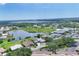 Aerial view of golf community including tennis courts, pool, lake, and putting green at 6702 Drewrys Blf, Bradenton, FL 34203