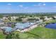 Panoramic aerial showcases clubhouse, pool, tennis, and lake surrounded by lush greenery at 6702 Drewrys Blf, Bradenton, FL 34203