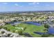 Breathtaking aerial view capturing the community, golf course, and picturesque lake at 6702 Drewrys Blf, Bradenton, FL 34203