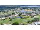 Aerial view of community with golf course, pond and clubhouse at 6702 Drewrys Blf, Bradenton, FL 34203