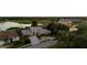 Expansive property featuring manicured landscaping, a serene lake view, and a beautiful light gray tiled roof at 6702 Drewrys Blf, Bradenton, FL 34203