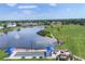 Scenic aerial view showcases the community lake and lawn bowling with covered seating areas at 6702 Drewrys Blf, Bradenton, FL 34203