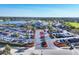 An aerial view of a clubhouse surrounded by a parking lot and golf course at 6702 Drewrys Blf, Bradenton, FL 34203