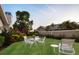 Landscaped backyard with seating and a well-maintained lawn at 6702 Drewrys Blf, Bradenton, FL 34203